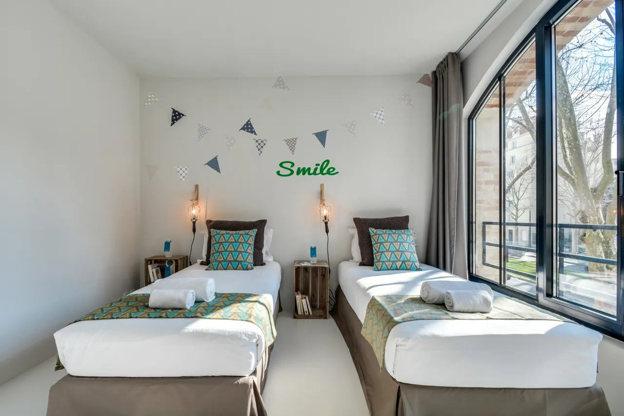 Lit simple dans CoAppart Partagé - Salon de la Franchise